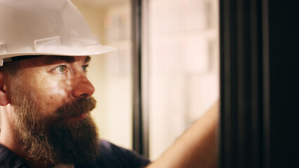 Man, electrician and check machine in server room for inspection, electric maintenance and diagnostics. Male person, hardhat and database to repair cable, monitor system and troubleshooting of safety