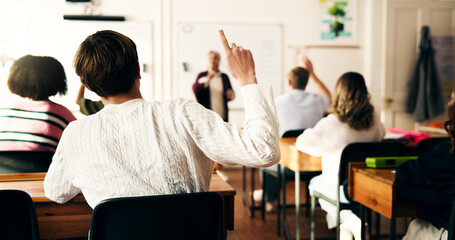 Back, teenager and students with raised hands in class for question, participation and solution....