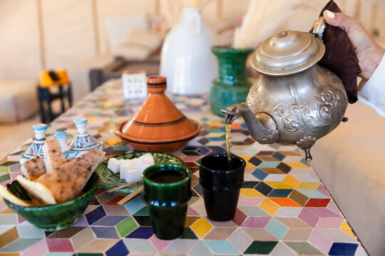 Moroccan tea pouring in luxury desert tent with traditional service