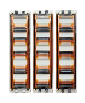 Three rectangular electronic components, vertically aligned, exhibiting layered color variations in bands