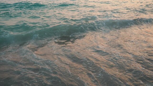 Waves gently roll onto the sandy shores of Canj, Bar, with the soft hues of morning light reflecting off the tranquil waters of the Adriatic Sea, creating a serene atmosphere