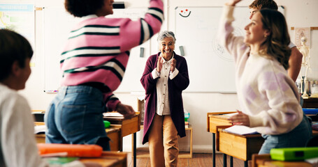 Teacher, girl and applause for high five in classroom with goals, excited or celebration for test results. Mature woman, pupil and happy with success, grade announcement and achievement at school