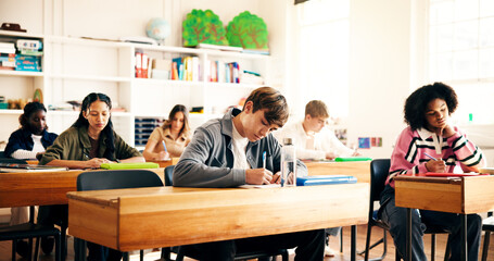 Writing, education and students in classroom for college admission tests, thinking and quiz. Aptitude assessment, knowledge and academy with people in high school for lesson or scholarship exam