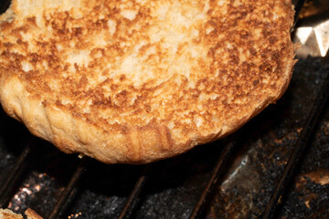 Close up of toasted burger bun being grilled