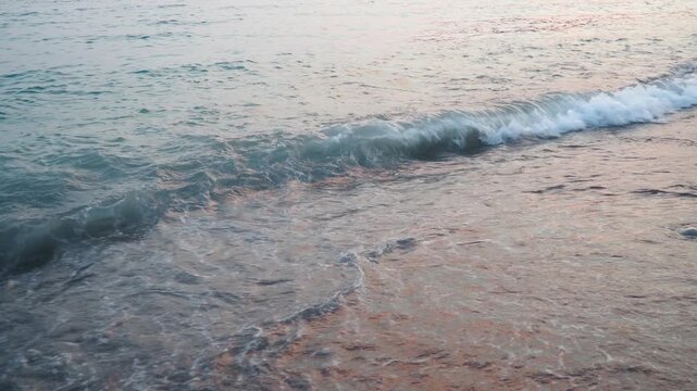 A serene morning unfolds at the sandy beach of Canj, Montenegro. Waves softly break on the shore of the Adriatic Sea, creating a peaceful atmosphere. The stunning water reflects the morning light