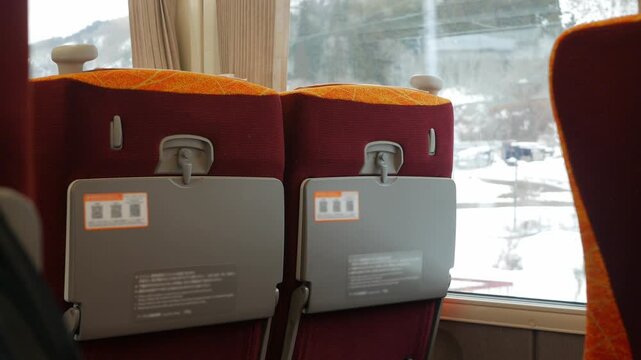 Closeup shot of selected view to rows of seats inside a express train wagon commuter while running in japan. View inside empty Bullet high speed rapid exprress Train