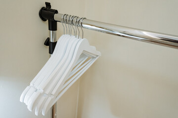 I have efficiently arranged and organized White Hangers on a sturdy Metal Rod to enhance Clothing...