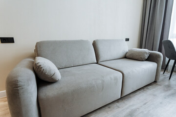 Discover a stylish modern sofa set in a minimalist living room, enhancing comfort and decor. This elegant piece promotes relaxation and suits a refined lifestyle, ideal for any home