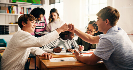 Education, team and student in classroom with fist bump, success and collaboration in creative work. Smile, fun and scholar in art room with stationary, achievement and support for group activity.