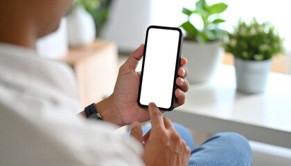 Person holding a blank screen phone indoors