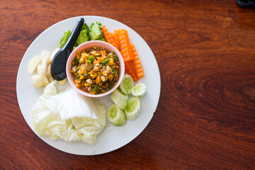 Spicy crab roe chili sauce served with many kinds of fresh vegetables. Thai called Nam Prik Kai Poo