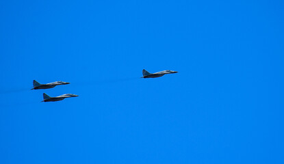 Military planes performing low pass maneuver over Belgrade city sky. Captured on August 2, 2025, during military aviation display event.