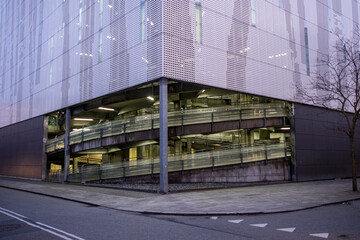 Parking building facade illuminated at dusk in Orestad Copenhagen, symbolizing urban infrastructure, contemporary architecture and modern city planning