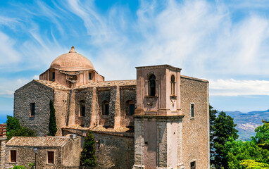 beautiful view of a nice old castle among rocks and green trees on background