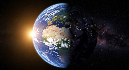 A dramatic view of Earth from space, showcasing the stunning day-night terminator line. The bright light of the sun illuminates the African and European continents