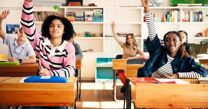 Question, class and students in classroom at high school with learning, education or participation in lesson. Teen, group and people raising hands for knowledge, academic development and interaction
