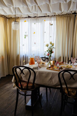 Elegant dining setup with floral decorations and inviting ambiance in a cozy room