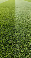 Overhead close-up of lush green football field grass with striped pattern.