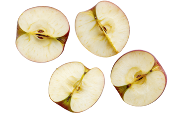 Four apple halves arranged on black background.  Close-up view of the cross-section, showing the core, flesh, and red skin.  Fresh and healthy