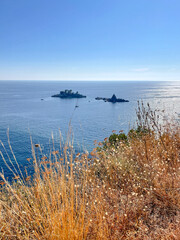 photo of the Adriatic Sea with an endless horizon and two islands in the distance. Filmed in Montenegro, featuring shimmering turquoise water, calm waves and a relaxing Mediterranean 