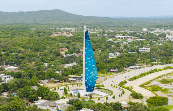 Aerial view of the Ventana de Sue&Atilde;&plusmn;os monument shining with its blue facade amidst the green landscape and urban sprawl, Barranquilla, Atlantico, Colombia.
