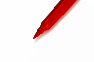 Close-up of a red marker tip. The tip is a pointed, fine-tipped design, with a shiny red plastic body
