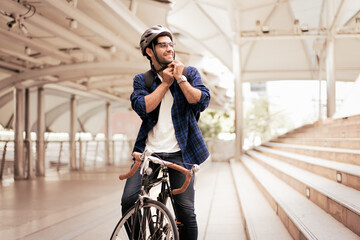 Smart businessman ride bicycle in downtown. Environmentalist commuting by cycling reduce carbon...