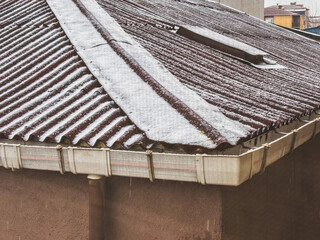 Snow Melting on a Red Corrugated Roof