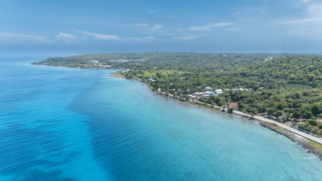 Aerial view of turquoise waters meet the verdant coastline, where a road traces the edge of the island, San Andr&Atilde;&copy;s, San Andres and Providencia, Colombia.