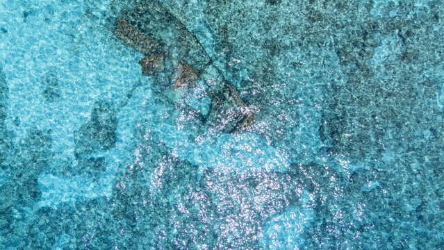 Aerial view of a shipwreck resting in the turquoise sea, its dark form contrasting with the vibrant waters, San Andr&Atilde;&copy;s, San Andres and Providencia, Colombia.