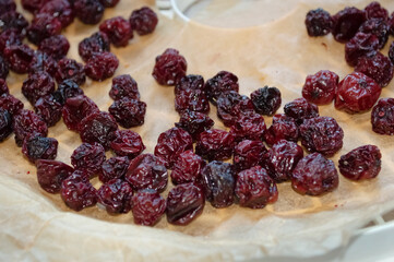 Close up of dried cherries on a tray in a dryer