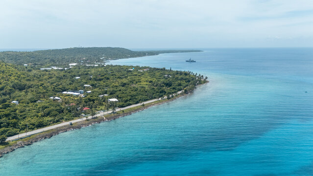 Aerial view of turquoise waters meet the lush green coastline, where a road traces the island's edge, San Andr&Atilde;&copy;s, San Andres and Providencia, Colombia.