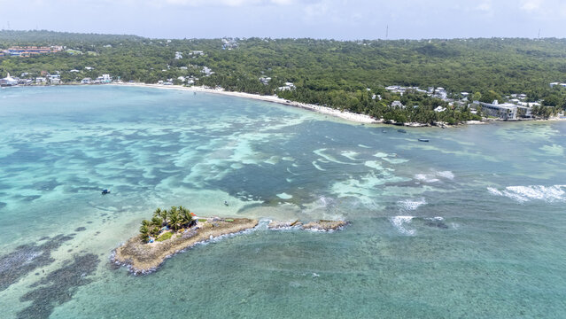 Aerial view of a small island with lush greenery surrounded by turquoise waters, near a coastline with sandy beaches, San Andr&Atilde;&copy;s, San Andres and Providencia, Colombia.
