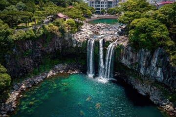 Obraz premium Aerial View of Cheonjeyeon Waterfall on Jeju Island, South Korea. Scenic Waterfall Drone Tour from Up High