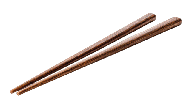 Two wooden chopsticks angled against a black background