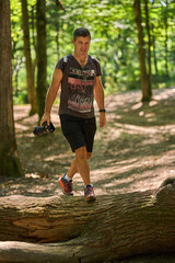 Man hiking with camera in forest