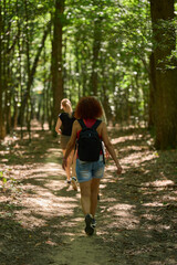 Women trekking on forest path