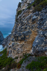 A dramatic cliff face with rugged rock textures