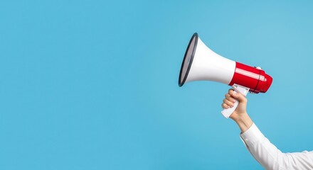 Close-up of a hand holding a megaphone against a bright blue background, ready to broadcast a message.