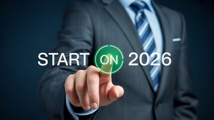 Businessman presses start button on 2026 for future business success and planning