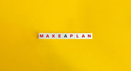 Make a Plan Text on White Tiles over Yellow Background