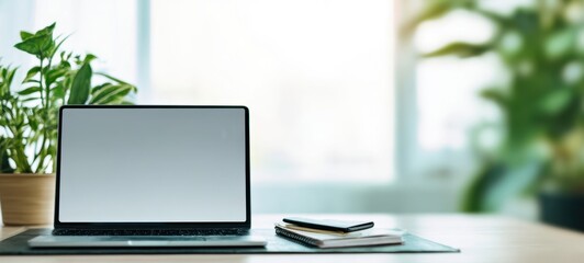 The sleek laptop positioned on a serene workspace surrounded by lush plants.