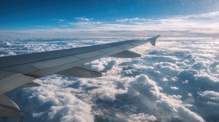 Obraz premium airplane wing above fluffy clouds