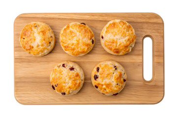Five assorted scones on a wooden board isolated on transparent background
