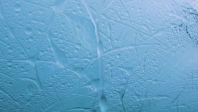 Glacial Wonder: A mesmerizing macro view of a glacial landscape, showcasing the intricate patterns of ice with a spectrum of cool blue hues, hinting at the raw, untouched beauty of nature.