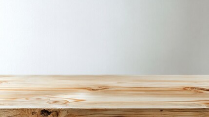 Fototapeta premium A simple wooden tabletop with a light, minimalist background, ideal for displaying products or food.