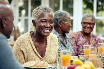 Group of friends enjoying a cheerful breakfast gathering in a bright, cozy dining space on a sunny morning