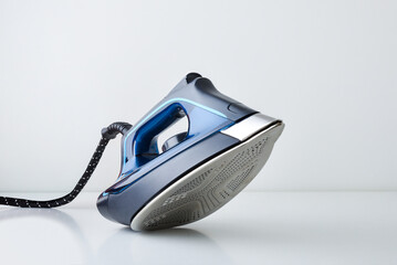 Steam iron showing sole with steam vent holes isolated white