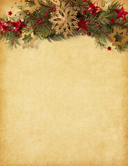 Fir branch with red and gold Christmas ornaments on  aged paper background. Vintage  Christmas and New Year holidays background.  Flat lay.