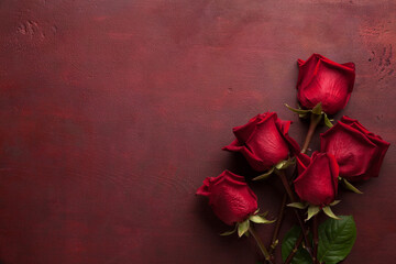Five red Roses lie on dark red wooden background. Flat lay